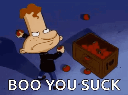 A Cartoon Character Is Standing Next To A Box Of Tomatoes With The Words Boo You Suck Below Him GIF