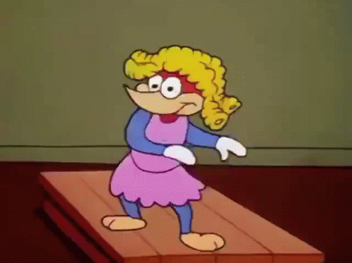 A Cartoon Character Is Standing On A Wooden Surface GIF