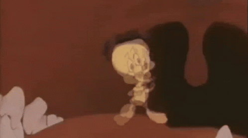 A Cartoon Character Is Walking Through A Cave While Holding A Sword . GIF