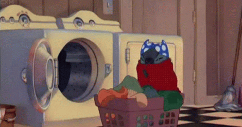 A Cartoon Character Is Wrapped In A Blanket And Sitting In A Laundry Basket . GIF