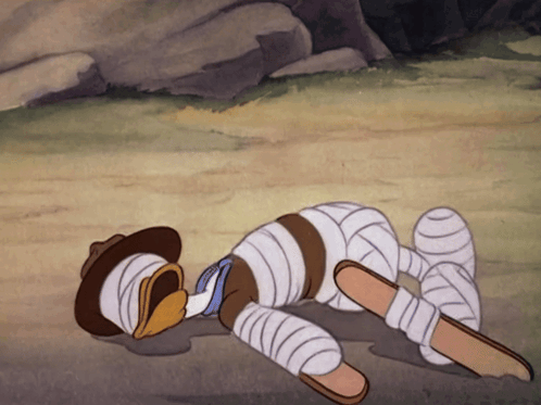 A Cartoon Character Laying On The Ground With Bandages On His Legs GIF