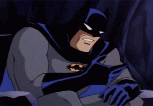 A Cartoon Character Named Batman Is Sitting Down With His Head Resting On His Arm GIF