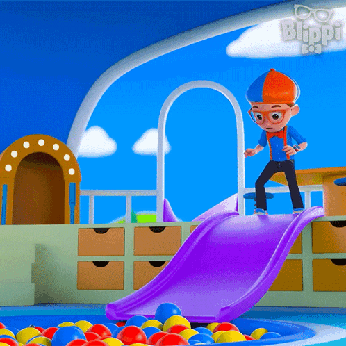 A Cartoon Character Named Blippi Is Playing On A Slide In A Pool Of Balls GIF