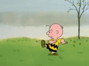 A Cartoon Character Named Charlie Brown Is Standing In A Field GIF