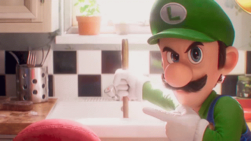 A Cartoon Character Named Luigi Is Pointing At Something In A Kitchen GIF