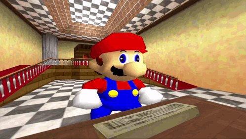 A Cartoon Character Named Mario Is Sitting At A Desk With A Keyboard GIF