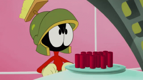 A Cartoon Character Named Marvin The Martian Looks At A Plate Of Red Tubes GIF