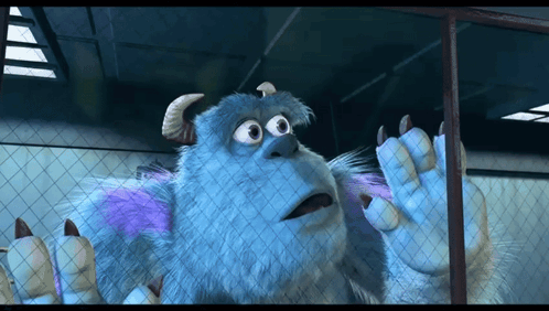 A Cartoon Character Named Sulley Is Behind A Fence GIF