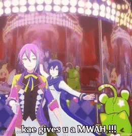 A Cartoon Character Says Kae Gives U A Mwah In Front Of A Merry Go Round . GIF