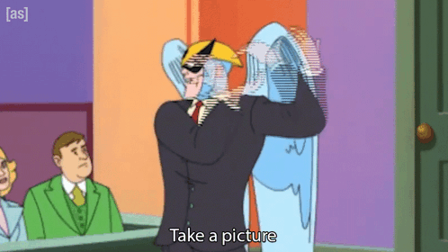 A Cartoon Character Says Take A Picture While Holding A Ghost GIF