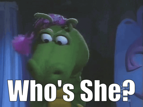 A Cartoon Character Says Who 'S She In Front Of A Curtain GIF