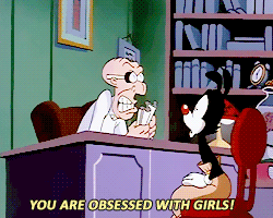 A Cartoon Character Says " You Are Obsessed With Girls " While Sitting At A Desk GIF
