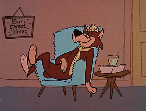 A Cartoon Character Sits In A Chair With A Sign That Says Home Sweet Home GIF
