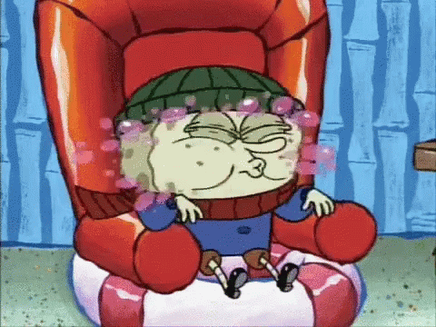 A Cartoon Character Sitting In A Chair With Bubbles Coming Out Of His Eyes GIF