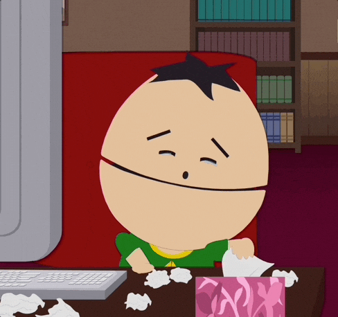 A Cartoon Character Sitting In Front Of A Computer With A Box Of Tissues GIF