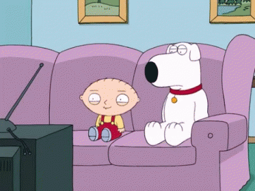 A Cartoon Character Sitting On A Couch Next To A White Dog GIF