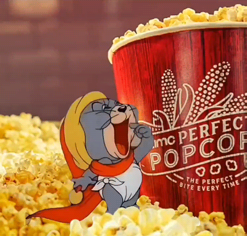 A Cartoon Character Standing Next To A Bucket Of Popcorn That Says Perfect Popcorn GIF