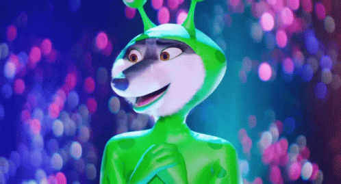 A Cartoon Character Wearing A Green Alien Costume Is Standing In Front Of A Blurry Background . GIF