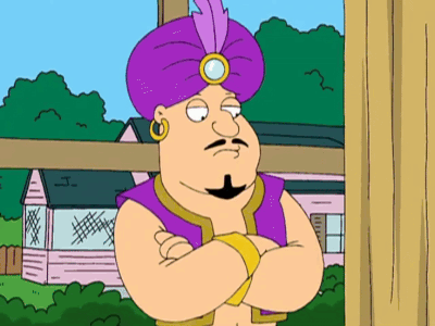 A Cartoon Character Wearing A Purple Turban Stands With His Arms Crossed In Front Of A House GIF