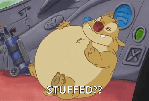 A Cartoon Character With A Big Belly Is Sitting On A Red Carpet And Says Stuffed ? GIF