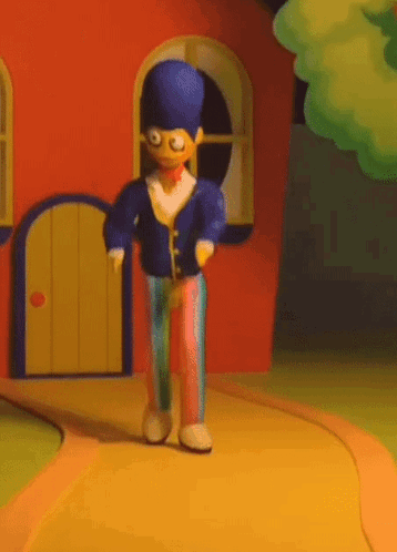 A Cartoon Character With A Blue Hat Is Walking Down A Path GIF