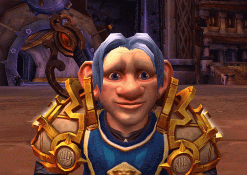 A Cartoon Character With A Blue Shirt And Gold Armor Looks At The Camera GIF