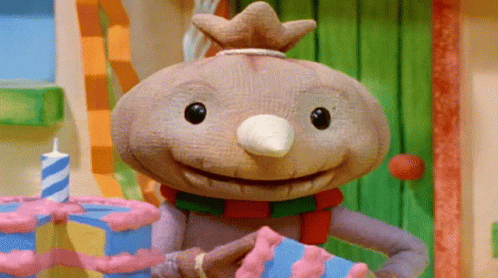 A Cartoon Character With A Crown On His Head Is Holding A Cake GIF