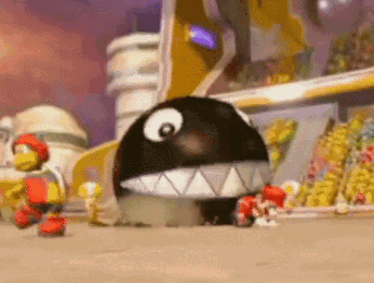 A Cartoon Character With A Large Black Ball With A Big Eye And Teeth GIF
