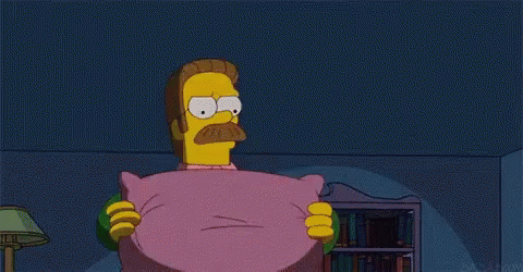 a cartoon character with a mustache is holding a pink pillow .