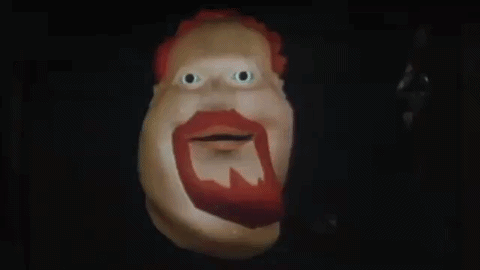 A Cartoon Character With A Red Beard Is Smiling And Says Hiya Slugger In The Dark . GIF
