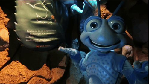 A Cartoon Character With A Sign That Says Bugs Life GIF