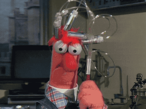 A Cartoon Character With Big Eyes Is Holding A Pair Of Scissors In A Laboratory GIF
