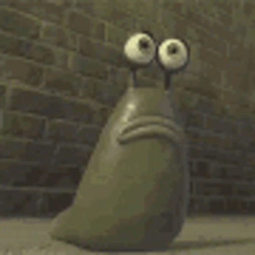 A Cartoon Character With Big Eyes Is Sitting In Front Of A Brick Wall With Its Mouth Open . GIF