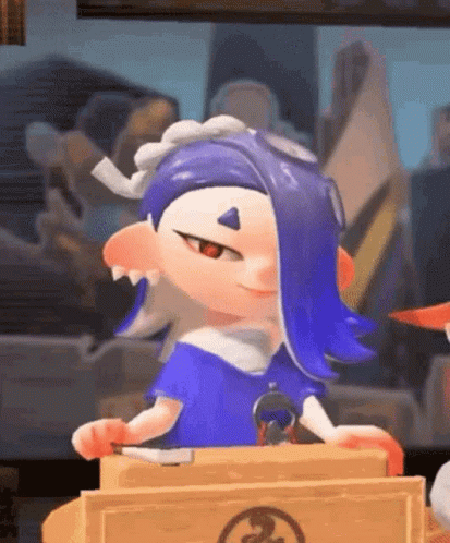 A Cartoon Character With Blue Hair Is Sitting At A Table Holding A Knife And Smiling . GIF