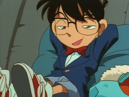 A Cartoon Character With Glasses And A Bow Tie Is Sitting On A Chair GIF