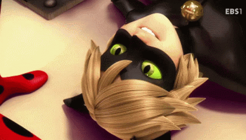 A Cartoon Character With Green Eyes Is Laying Down On The Floor GIF