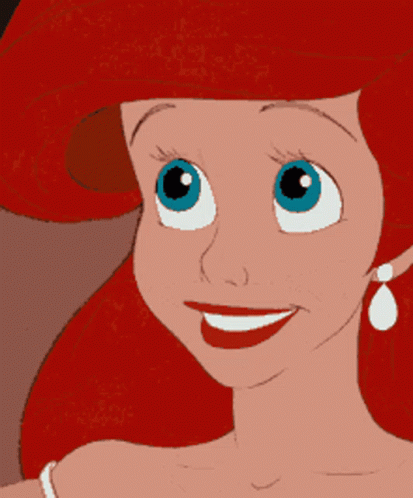 A Cartoon Character With Red Hair And Blue Eyes Is Smiling GIF