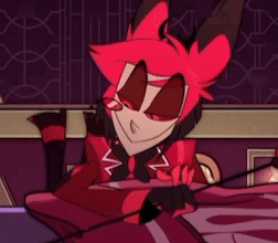 A Cartoon Character With Red Hair Is Sitting On A Bed And Smiling . GIF