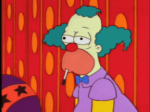 A Cartoon Clown Smoking A Cigarette In Front Of A Red Curtain GIF