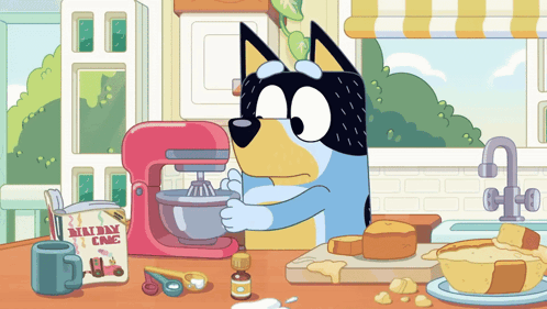A Cartoon Dog Is Mixing Something In A Mixer With A Box Of Millway Cake Mix GIF
