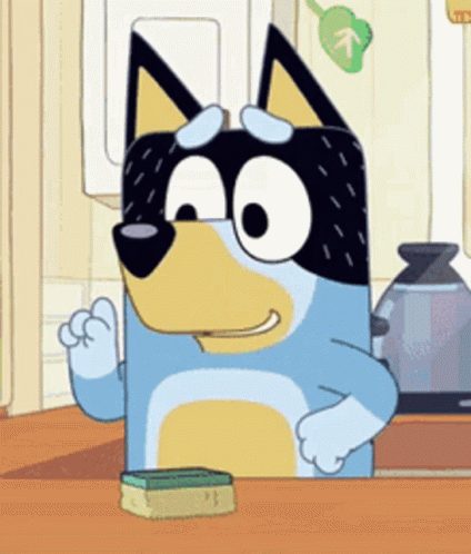 A Cartoon Dog Is Sitting At A Kitchen Counter With A Sponge . GIF