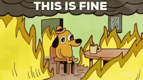 A Cartoon Dog Is Sitting At A Table With A Cup Of Coffee In Front Of A Fire With The Words This Is Fine Above Him . GIF