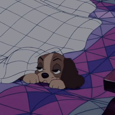 A Cartoon Dog Is Sleeping Under A Blanket On A Bed GIF