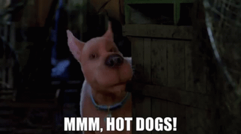 A Cartoon Dog Is Standing Next To A Wooden Crate And Says Mmmm Hot Dogs ! GIF