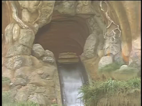 A Cartoon Drawing Of A Zip Ride Going Through A Cave GIF