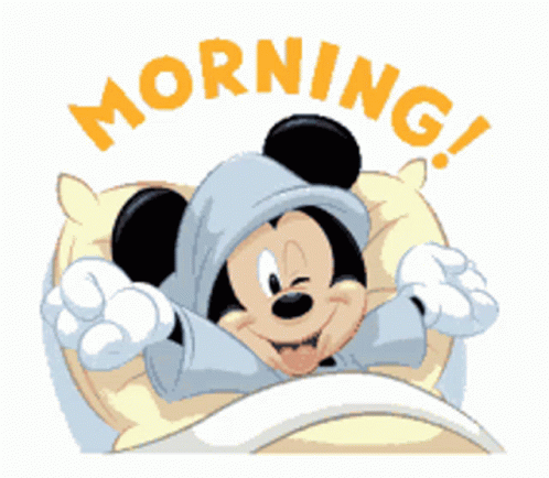 A Cartoon Drawing Of Mickey Mouse Laying In Bed With The Words Morning Behind Him GIF