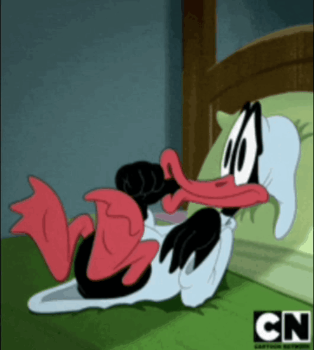 a cartoon duck is laying on a bed with cn written on the bottom