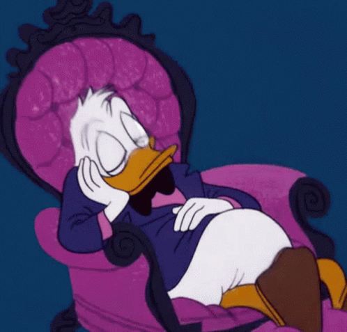 A Cartoon Duck Is Sitting In A Purple Chair GIF
