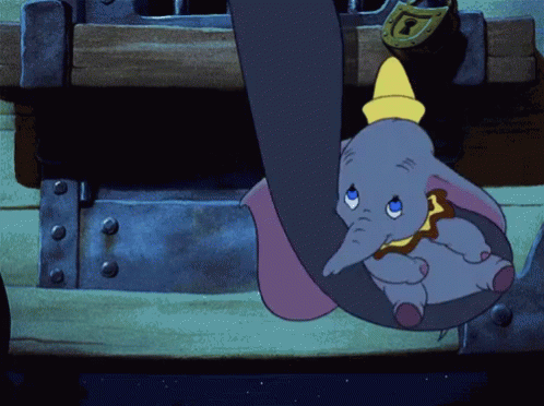 A Cartoon Elephant Hanging From A Trunk With A Yellow Hat On GIF