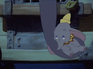 A Cartoon Elephant Is Hanging From A Trunk With A Lock On It GIF